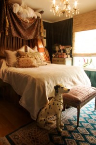 Silk drapings surround the well appointed bed.